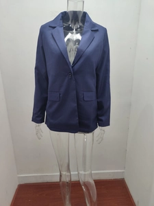 Detailed view of dark blue blazer featuring notched lapels and single-button closure