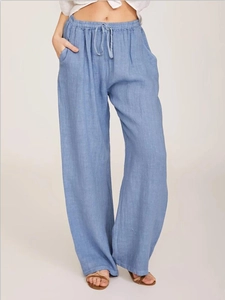 Detailed macro view of elastic drawstring waist and pocket on light blue linen pants