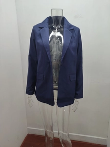 Detail of single-breasted navy blue blazer with notched lapels and flap pockets
