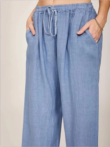 Detail of greyish-blue cotton linen wide-leg trousers with elastic drawstring waist