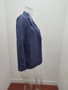 Detail of navy blue women's blazer featuring notch lapels and a functional flap pocket