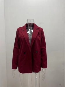 Detailed macro view of wine red blazer jacket featuring notched lapels and double buttons