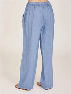 Detail view of light blue linen wide-leg pants showing elastic high waist and loose fit design