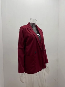 Detail of burgundy women blazer featuring notch lapels and functional front patch pockets