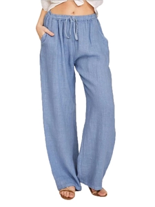 Detail of light blue linen wide-leg pants featuring an elastic drawstring waistband
