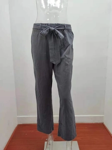 Detail of dark grey wide-leg linen pants with elastic waist and matching tie belt
