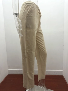Detail of beige cotton linen wide leg pants with drawstring waist and side pockets