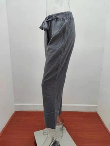 Detail view of grey cotton linen wide-leg pants with elastic waist and bow belt