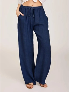Detail of loose fit cotton linen pants with elastic drawstring waist in dark indigo blue