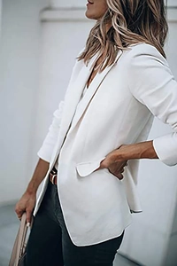 Detail view showing professional white blazer lapels and high-quality textured fabric
