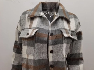 Detailed view of the thick plaid flannel shacket with front pockets and tortoise buttons