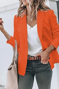 Detailed close-up of a loose fit orange blazer with lapel collar and single-breasted design