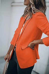 Detailed view of the notch lapel and front pockets on this orange casual women blazer
