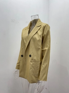 Detail view of khaki double-breasted blazer with peaked lapels and large resin buttons