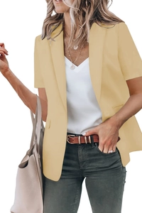 Detailed look at beige short-sleeve blazer with classic lapel and side pocket design
