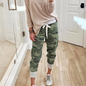 Detail of camouflage jogger pants with white drawstring and grey ribbed cuffs