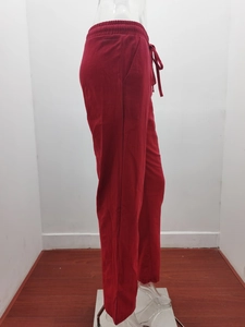 Detail view of deep red cotton linen pants featuring elastic drawstring waist and loose fit