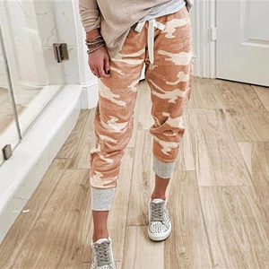 Detail view of camouflage joggers featuring a white drawstring waist and grey ribbed cuffs