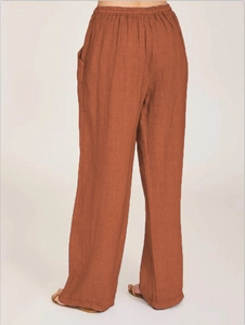 Rear view of caramel cotton linen wide-leg pants featuring elastic waist and side pockets