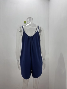 Detail view of the back pleats and thin straps on a navy blue summer romper pajama