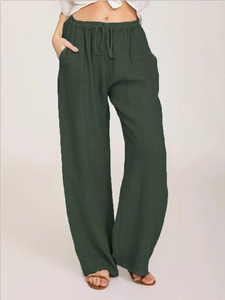 Detail of dark green cotton linen wide leg trousers featuring elastic drawstring waistband