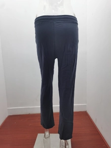 Detail view of elastic waistband and vertical texture on dark casual wide leg trousers