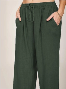 Detail view of elastic waist with drawstring on dark green cotton linen wide leg pants