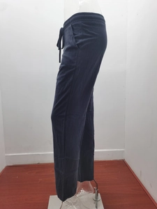 Detail view of dark grey cotton linen trousers with elastic drawstring waist and side pockets