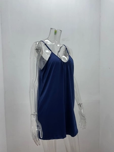 Detail of adjustable thin straps and pleated V-neckline on navy blue loose romper