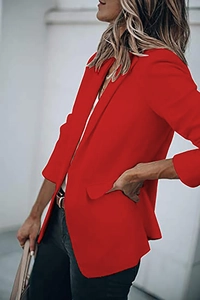 Detail of bright red blazer with classic notched lapels and side flap pockets on a model