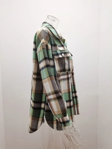 Detail view of plaid flannel shirt jacket with side slit hem and chest pocket