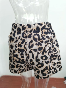 Close-up of leopard print shorts featuring elastic waistband and functional back pockets