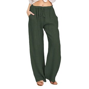 Detail view of dark green wide-leg trousers with drawstring elastic waist and pockets