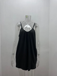 Detail of black V-neck sleepwear showing ruffled pleats and adjustable thin spaghetti straps