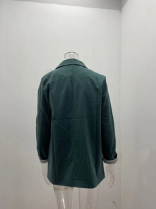 Rear view of deep green blazer with notched lapel and grey lining sleeve detail