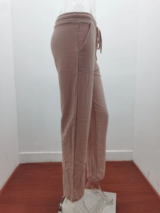 Detail view of pink cotton linen pants showing the drawstring waist and side pockets