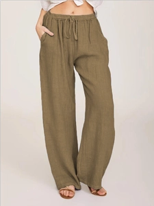 Detailed macro view of wide-leg cotton linen trousers with drawstring waist and pockets