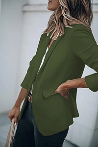 Close-up of deep green long-sleeved blazer featuring notch lapels and pocket details