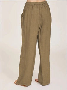 Detail view of cotton linen trousers showing elastic waistband and side pocket detail
