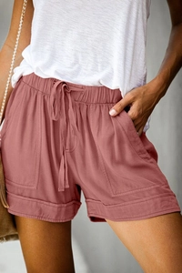 Detail of high waist drawstring shorts in dusty rose with large side pockets
