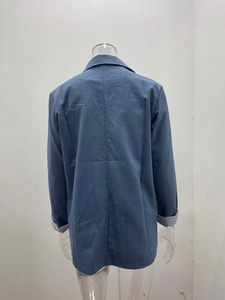 Rear view of long-sleeved hazy blue blazer with gray lining detail on the sleeve cuffs