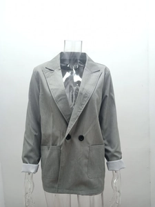 Detail view of grey double-breasted blazer with contrast white cuffs and large patch pockets