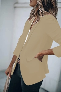 Detail view of khaki blazer featuring notch lapels and flap pockets for women