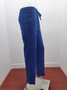 Detail of navy blue linen trousers showing elastic drawstring waist and side pockets