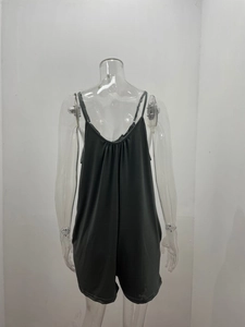Detail view of dark grey V-neck romper featuring pleated back and adjustable straps