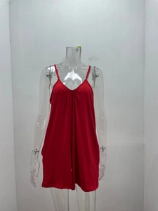 Detail of red V-neck sleeveless romper showing soft fabric and pleated chest design