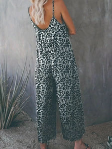 Detail of cross-back straps on women's leopard print jumpsuit with wide-leg trousers