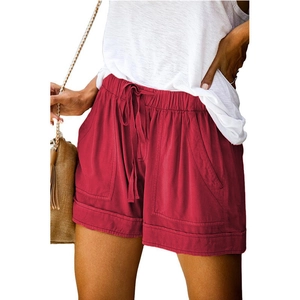 Detail of high-waist drawstring waistband and side pocket on brick red summer shorts