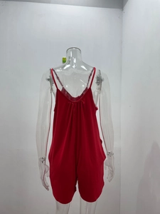 Detail view showing deep V back design and thin straps of red V-neck summer romper