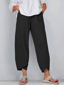Detail of black cotton linen wide leg pants featuring unique overlapping asymmetrical hem
